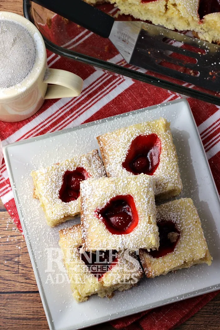 Overhead view of Shelly's Cherry Squares by Renee's Kitchen Adventures on a white plate with a red and white napkin under the plate