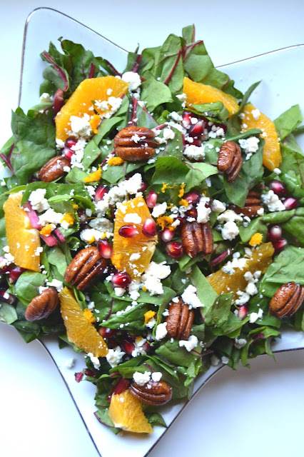 Christmas Salad- packed with Swiss chard, oranges, pomegranates, cinnamon pecans and blue cheese! www.nutritionistreviews.com