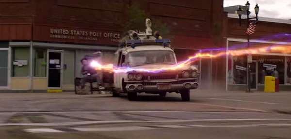 With Ecto-1 driven by her brother Trevor (Finn Wolfhard), Phoebe (Mckenna Grace) sits in the gunner seat as they chase after a spirit named Muncher (off-screen) in GHOSTBUSTERS: AFTERLIFE.