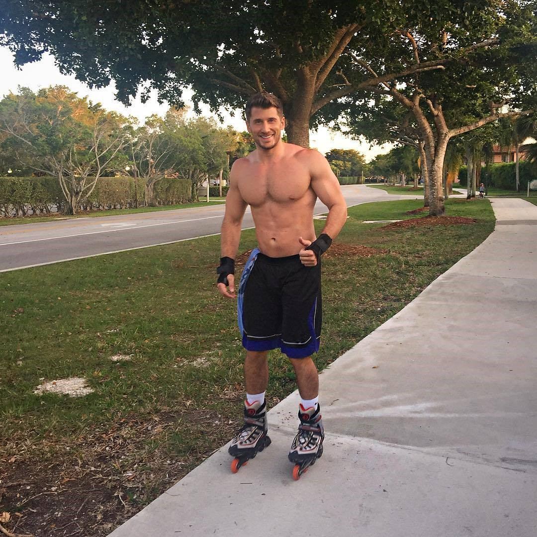 cute-muscular-gay-guys-smiling-roller-skating-shirtless-beefy-male-body-pecs-thumbs-up
