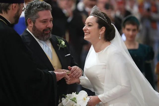 The bride Victoria Romanovna Bettarini wore a white satin gown by fashion designer Reem Acra, and the Lacis Tiara by Chaumet