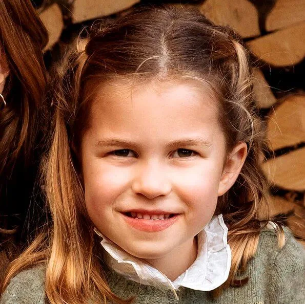 Prince George and Prince Louis. Kate Middleton wore a burgundy sweater and blouse by Sezane. Princess Charlotte wore a green knit sweater