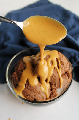 Take your ice cream to the next level with a drizzle of this 2 ingredient peanut butter magic shell. It is the perfect topping for your next sundae! spoon drizzling peanut butter magic shell over bowl of chocolate nice cream