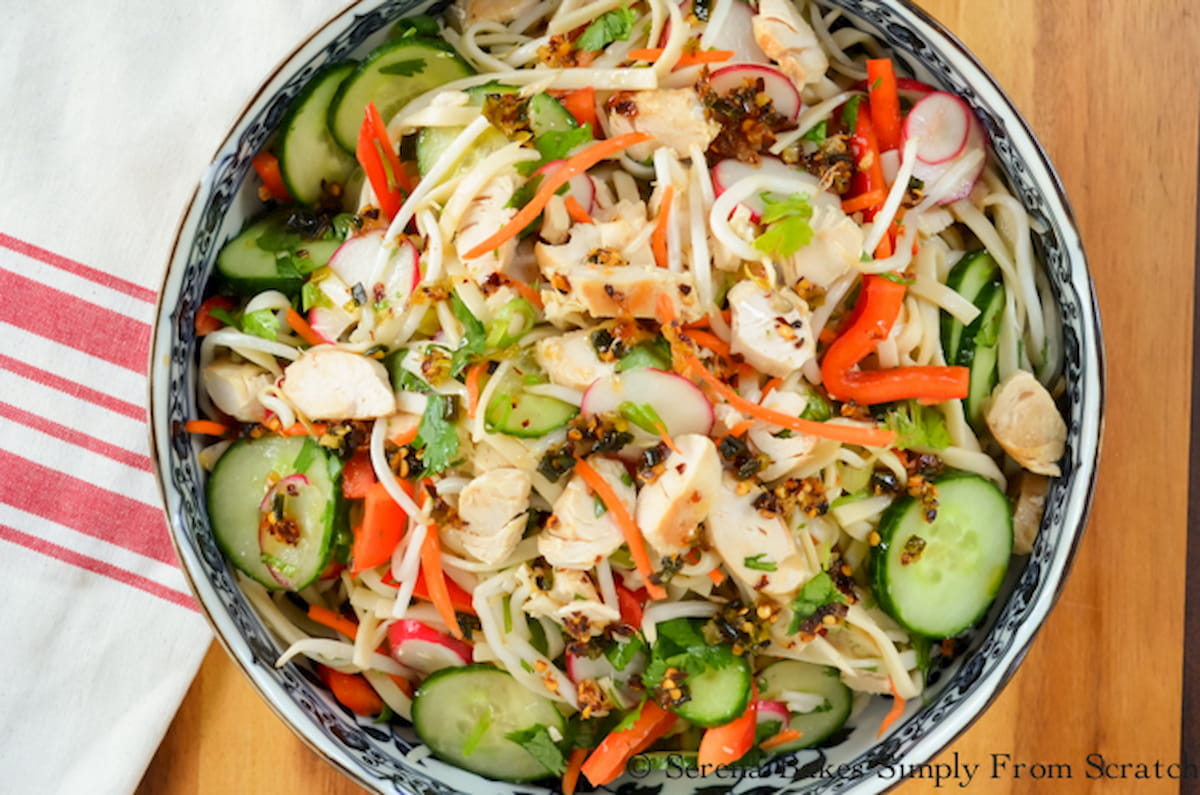 Asian Noodle Chicken Vegetable Salad with Chile Scallion Oil in a white bowl with blue design.