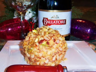 this is a cheese ball rolled in nuts and has a bottle of Champagne in the back