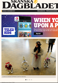 Tidningsframsida som visar luciatåg av robotar.