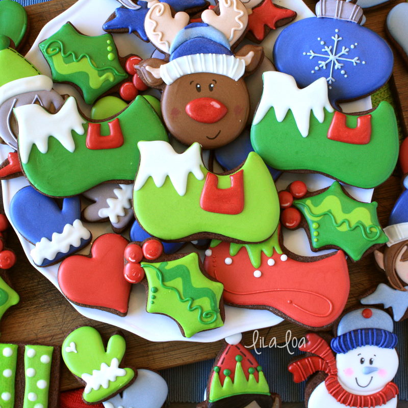 Brightly colored elf, Christmas, and winter decorated chocolate sugar cookies