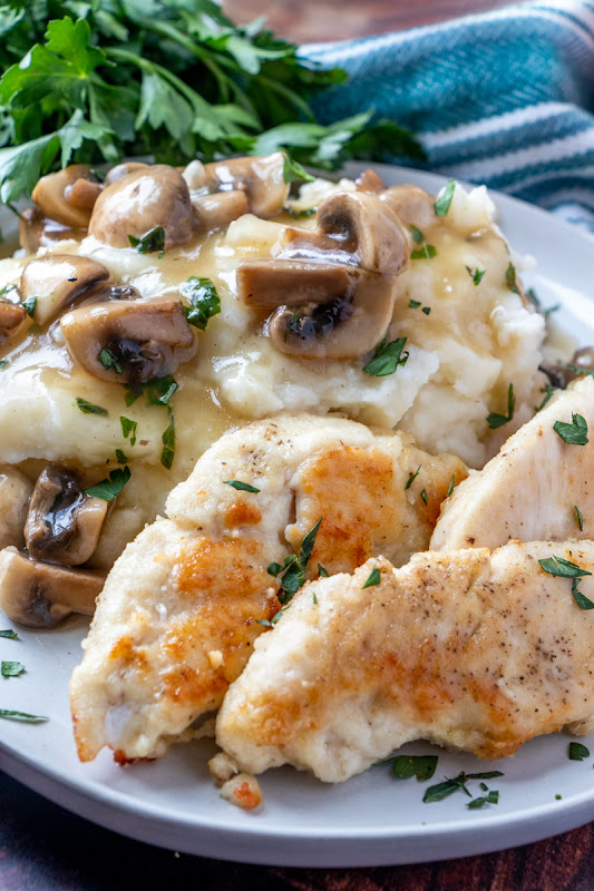 This easy meat and potatoes comfort food meal is perfect for a weeknight dinner, or even Sunday dinner! The mushrooms are delicious in the gravy with the chicken and you can serve with mashed potatoes, rice or pasta! Such a great homemade recipe!