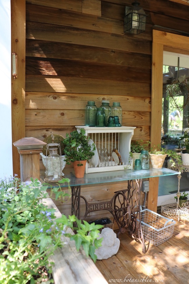 A small outdoor table serves as a storage table for collections