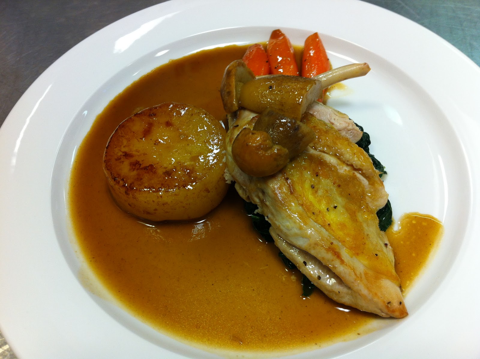 behind the frying pan Pan fried supreme of chicken,fondant potato