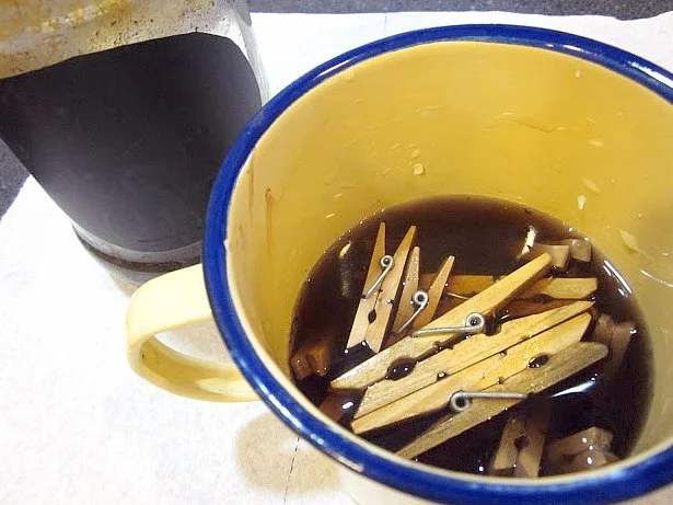 clothespins in a bowl of vinegar and steel wool