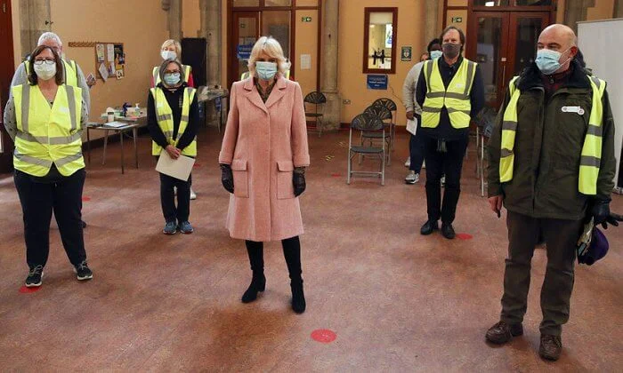 The Duchess met with those involved in the vaccination process, including NHS staff, volunteers and representatives. Pink wool coat and black boot