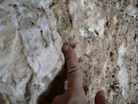 Simon pointing at chisel marks inside the Garden Tomb