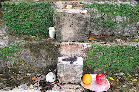 Incense and offerings at stone monument