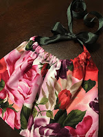 Beautiful floral valentine baby girl bib with adjustable sizing by Cerena Levene