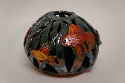 Unique and beautiful raku fired pottery vessel with fish bowl design.