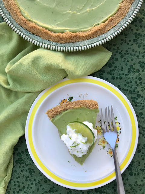 Lime avocado coconut pie with a slice on a plate.