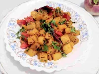 Serving shalgam ki sabzi in a bowl