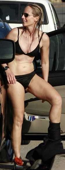 Helen Hunt takes bikini shower as she was surfing on Malibu beach.