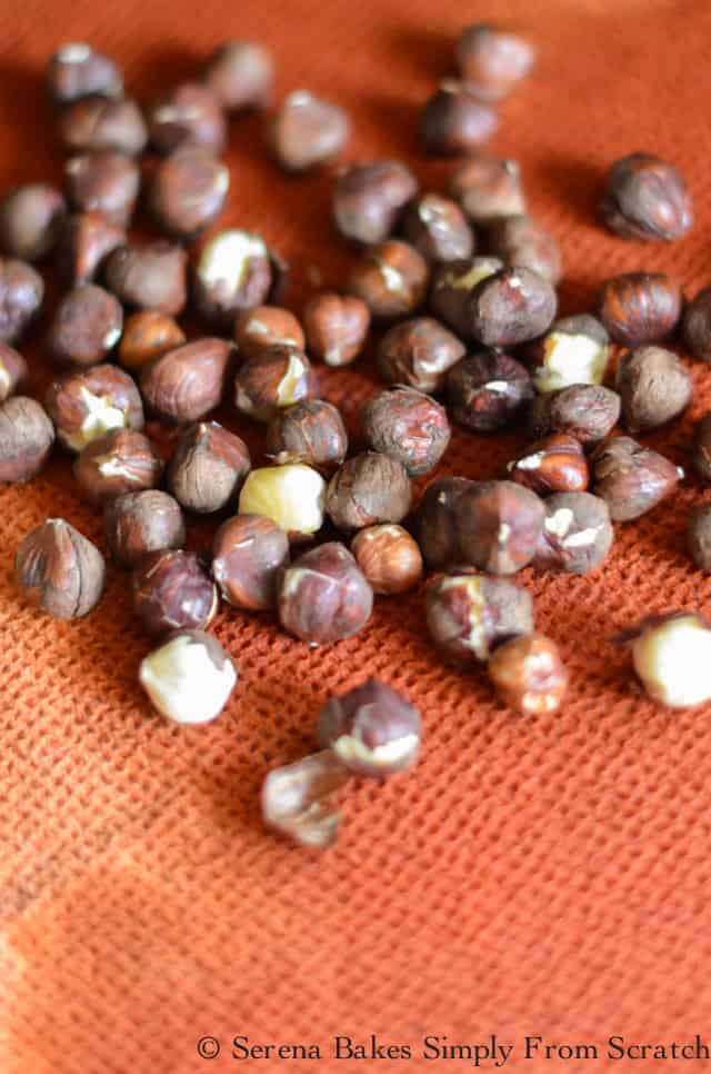 Roasted Hazelnuts being rubbed in cloth to remove skin for Candied Hazelnuts.