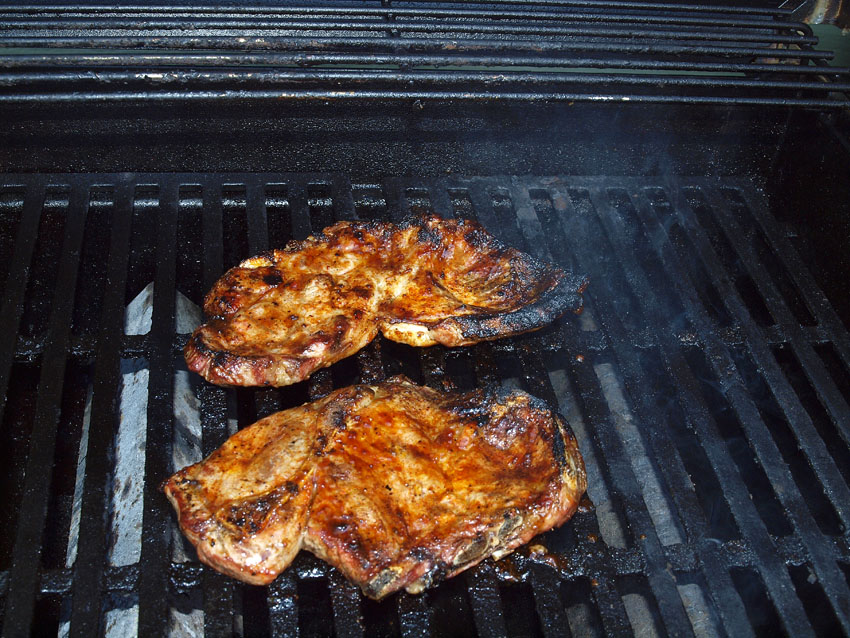 Pellet Smoker Cooking Grilled Pork Steaks, Fried Hash Browns and