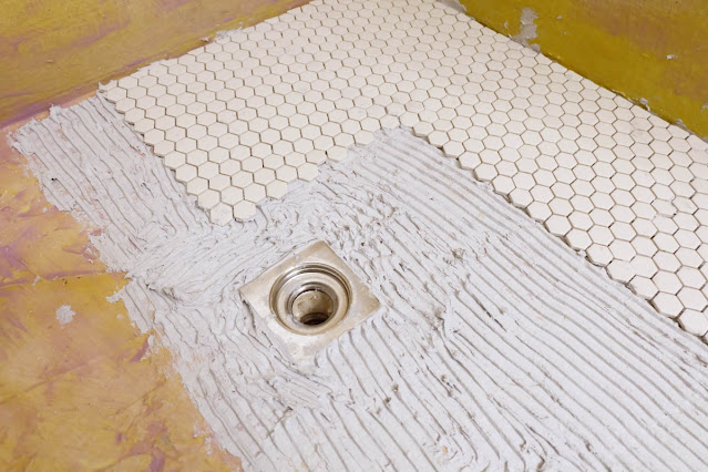 starting hex mosaic tile shower floor around stainless drain