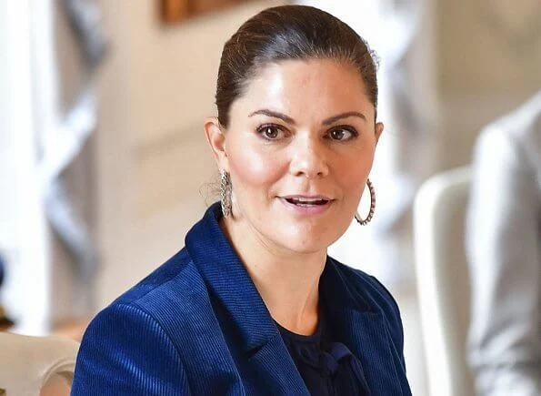 Princess Victoria wore a cord suit by Dagmar, and blue boots by af Klingberg, and pyramid earrings by Sophie by Sophie