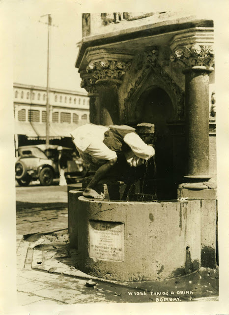 A+Man+is+Drinking+Water+from+a+Road+side+Tap+-+Bombay+(Mumbai)+Late+1920's