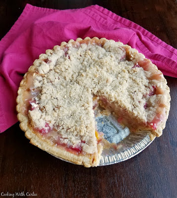 Peach rhubarb pie combines the tart taste of spring with summer's sweet fruit. Peach and rhubarb come together under a golden streusel in this perfect fruity pie. peach rhubarb pie with one slice missing