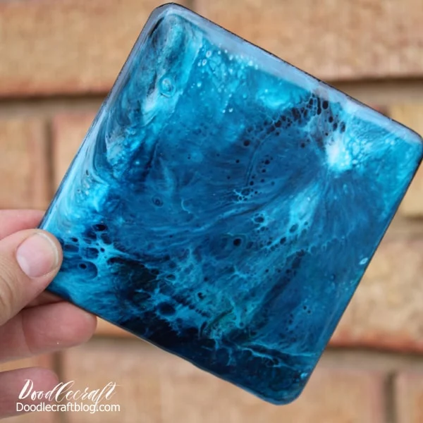 Make stunning galaxy coasters with high gloss resin and vivid colors. These amazing coasters are addicting to make with this fun resin pour technique.