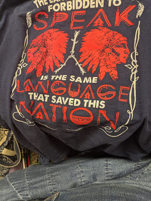 Blue red and white t-shirt: The Language they were forbidden to speak is the language that saved this nation.