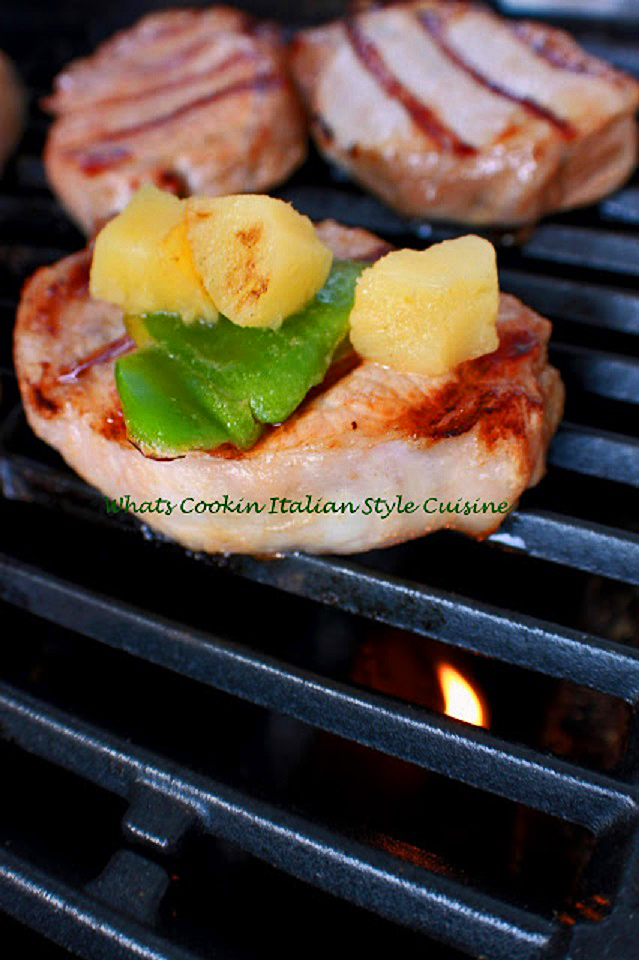 these are boneless pork chops that have been marinated and then cooked on indirect heat outside on a grill topped with pineapple and peppers with a delicious Polynesian sauce it was marinated in