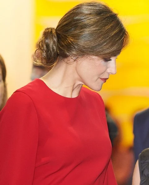 Queen Letizia carried Carolina Herrera Animal Print Clutch Bag and she wore Magrit Boots, red skirt and red blouse