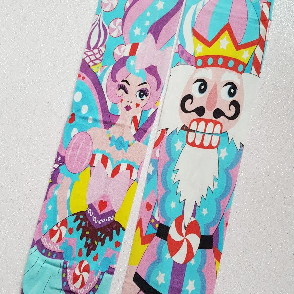 close up of legs of tights showing sugar plum fairy and nutcracker character down each leg