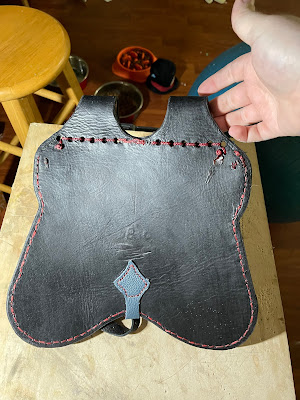 Back of the pouch; you can see a stamp from the brand on the leather.