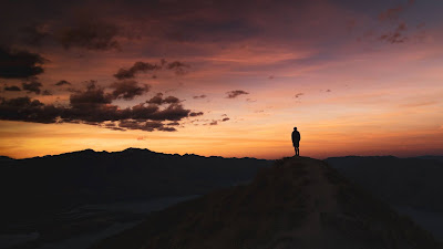 Lonely man, sunset clouds, mountain, landscape