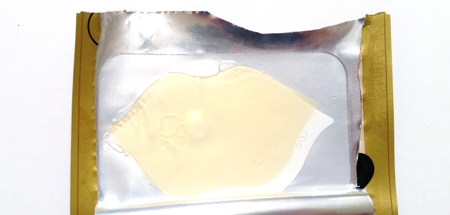 The lip mask in-between its plastic protective covers.