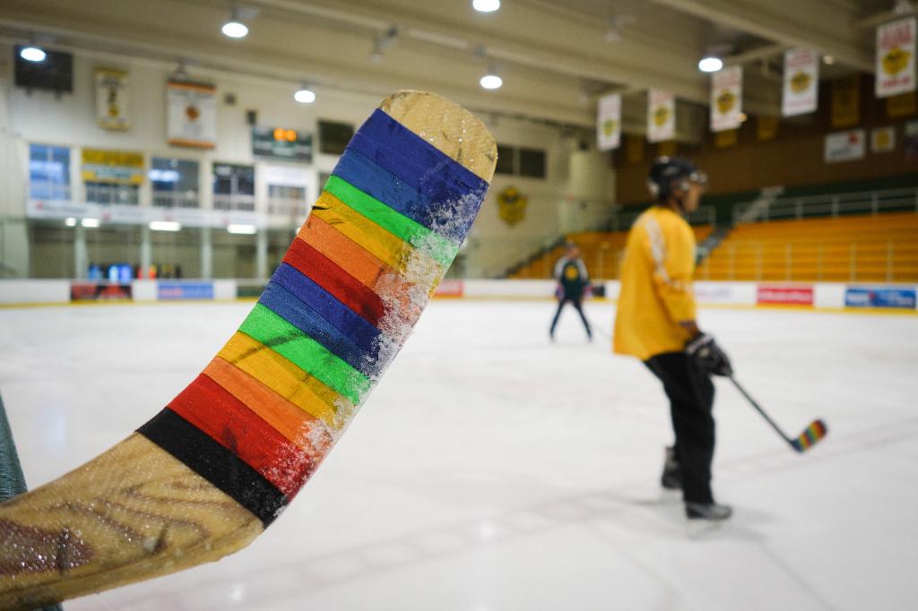 Finnish hockey player Harri Tikkanen puts rainbow decal on 