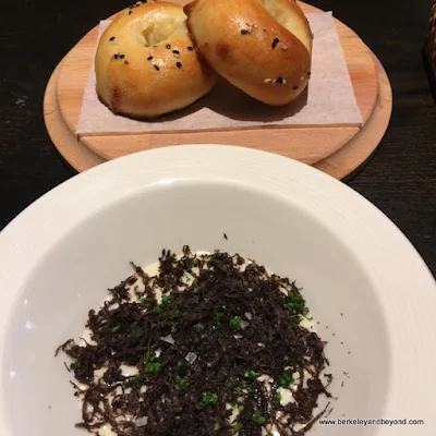 signature hot round naan buns made in the tandoor oven (they look like bagels), plus homemade butter and precious Australian black truffle at Campton Place Restaurant in San Francisco, California