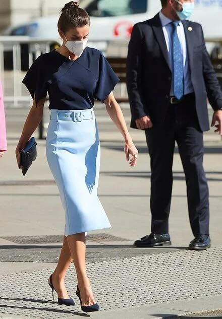 Queen Letizia wore a v-neck pure silk flared sleeves navy blue top and a sky-blue high waisted pencil skirt from Hugo Boss