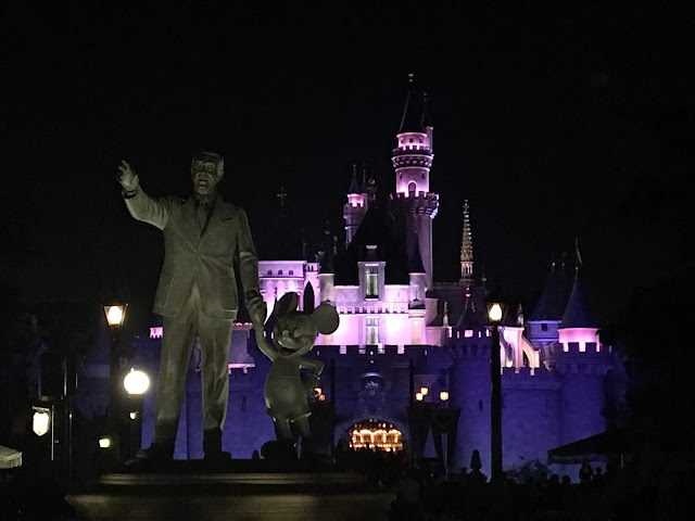 Partners Stature In Front of Sleeping Beauty Castle Disneyland at Night
