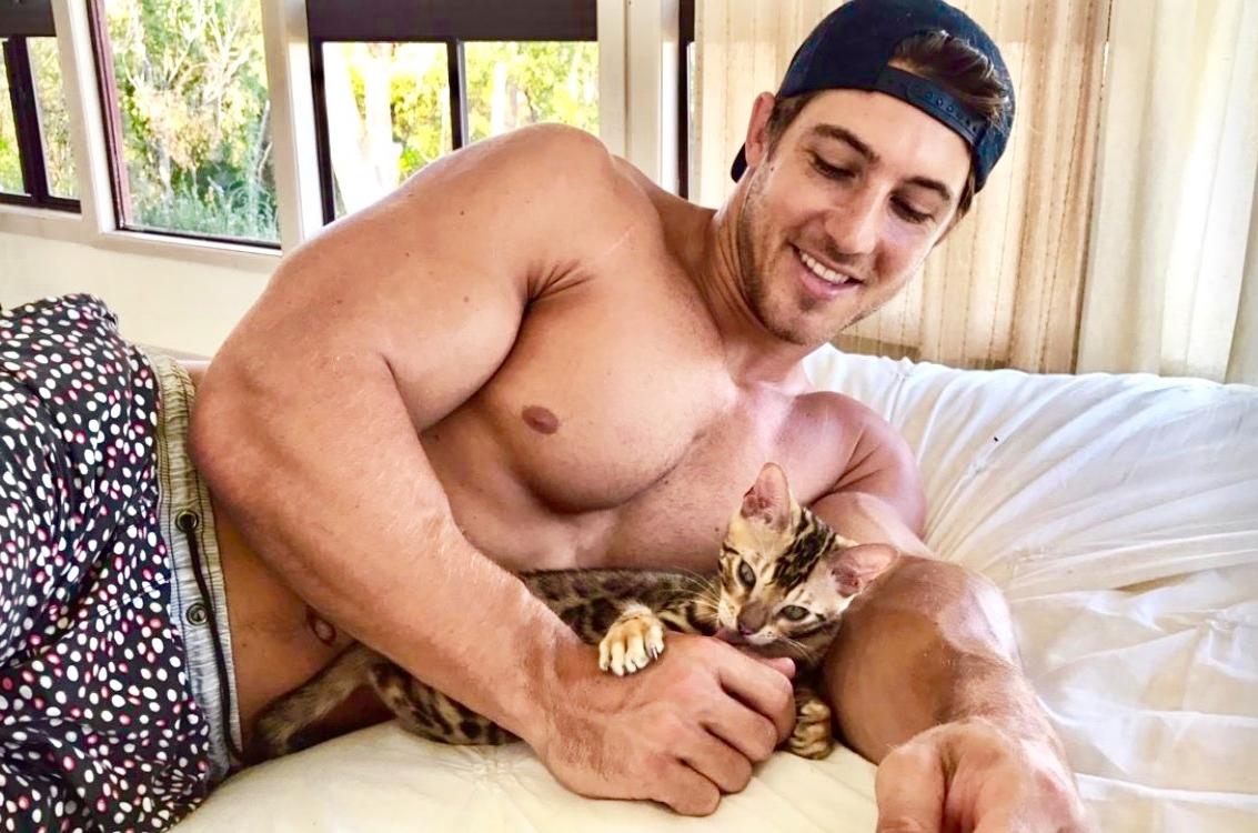 adorable-shirtless-hunk-pet-owner-smiling-bro-kitty-cat-playing-around-together