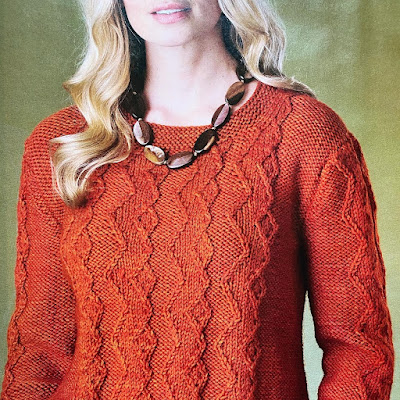 Close up of magazine page showing a model wearing a hand knitted sweater