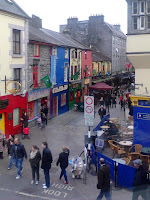 View over Quay Street from Cross Street, looking towards Spanish Arch:  Dillons Claddagh ring museum, Wooden Heart Toys, Neachtains pub - rainy holiday Sunday crowds