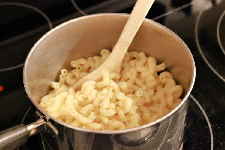 Laughing Cow Mac and Cheese process, pasta in pan ready to be coated in cheese sauce