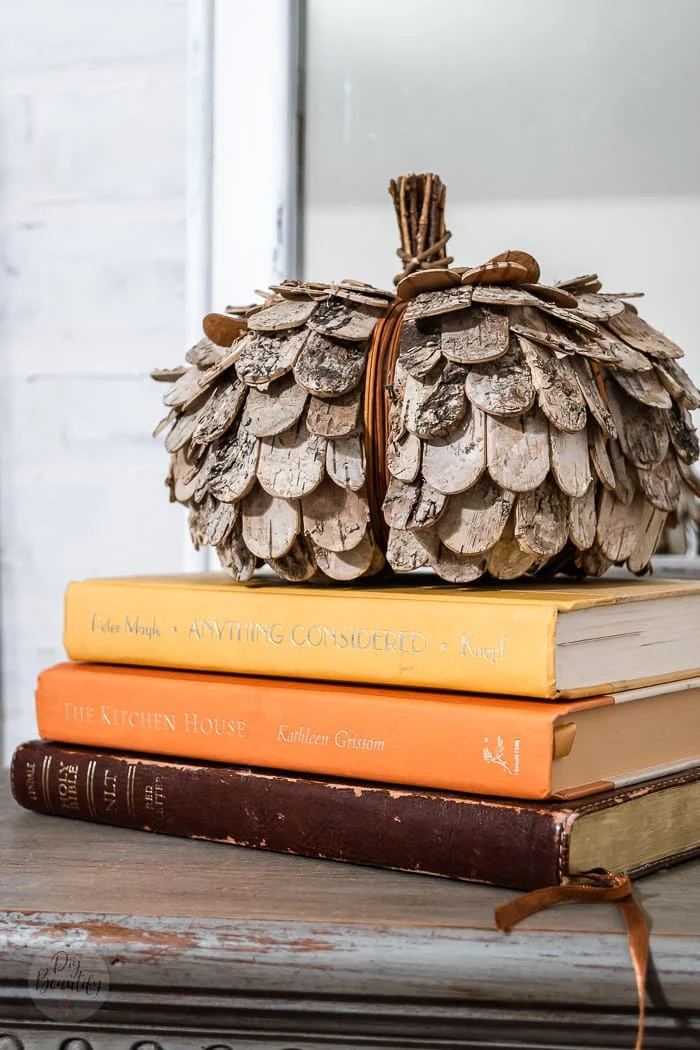 rustic pumpkin on stack of vintage books