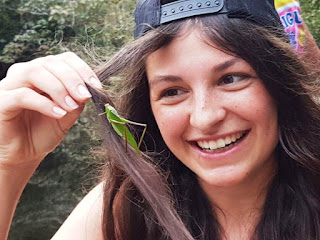 A leaf-shaped grasshopper in Ina's hair
