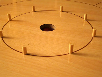 Crokinole - The 8 central wooden peggs. Some fit well whilst others do not!