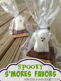 Packs of chocolate, graham cracker, and a ghost Peep with the words "Spooky S'mores Wedding Favors" digitally written below it.