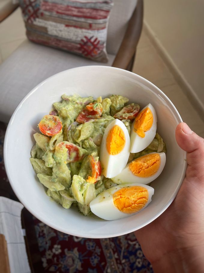one bowl of Creamy Avocado Breakfast Pasta topped with boiled eggs
